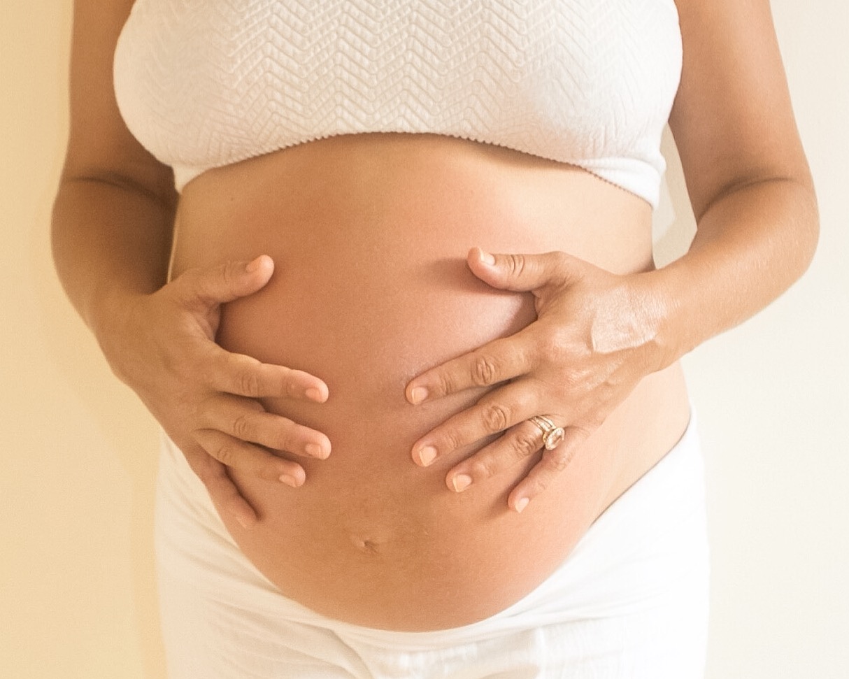 Image of Pregnant Female Holding her Stomach