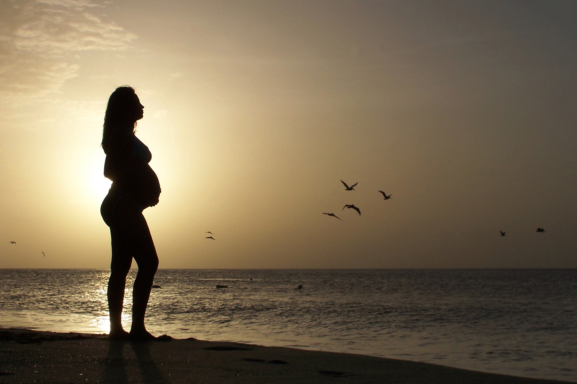 Image of Pregnant Woman Standing on the beach