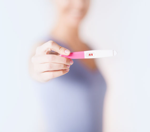 Image of Woman Holding a Pregnancy Test